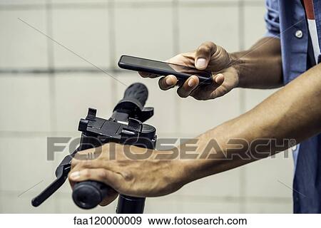 Young man using smart phone View Large Photo Image Stock Photo - Young man using smart phone. Fotosearch