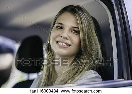 Young woman in car View Large Photo Image Picture - Young woman in car. Fotosearch