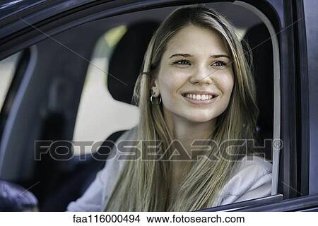 Young woman in car View Large Photo Image Picture - Young woman in car. Fotosearch