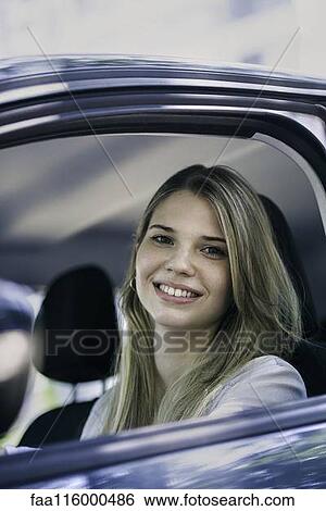 Young woman in car View Large Photo Image Stock Photograph - Young woman in car. Fotosearch