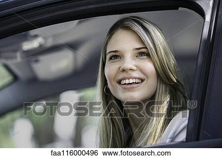 Stock Photograph - Young woman in car. Fotosearch