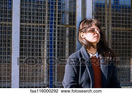 Young woman leaning on fence View Large Photo Image Stock Image - Young woman leaning on fence. Fotosearch