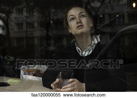 Young woman sitting in restaurant View Large Photo Image Stock Photography - Young woman sitting in restaurant. Fotosearch