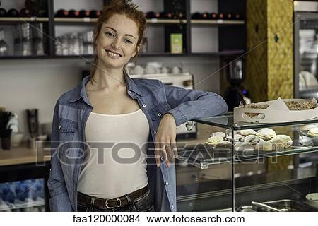 Young woman standing in bakery View Large Photo Image Picture - Young woman standing in bakery. Fotosearch