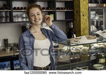 Young woman standing in bakery View Large Photo Image Stock Photography - Young woman standing in bakery. Fotosearch