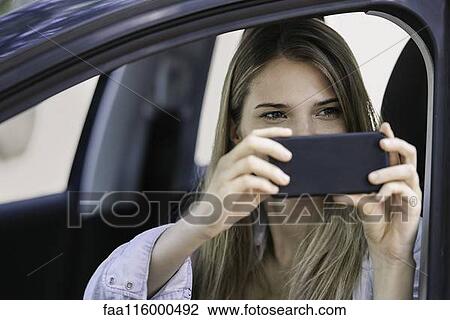 Young woman taking photograph View Large Photo Image Stock Image - Young woman taking photograph. Fotosearch