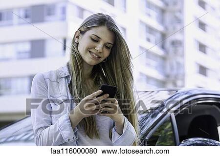 Young woman using smartphone View Large Photo Image Stock Image - Young woman using smartphone. Fotosearch