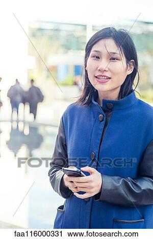 Young woman using smartphone View Large Photo Image Stock Image - Young woman using smartphone. Fotosearch