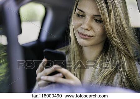 Young woman using smartphone View Large Photo Image Stock Image - Young woman using smartphone. Fotosearch