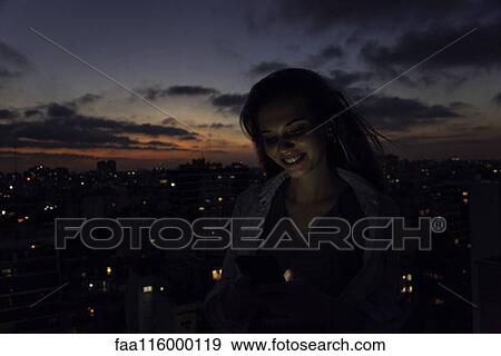 Stock Photo - Young woman using smartphone. Fotosearch