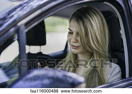Stock Photo - Young woman using smartphone. Fotosearch
