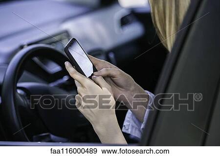 Stock Photo - Young woman using smartphone. Fotosearch