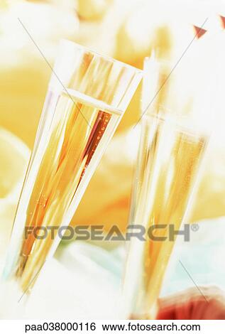Stock Photograph - Flutes of champagne, blurred. Fotosearch