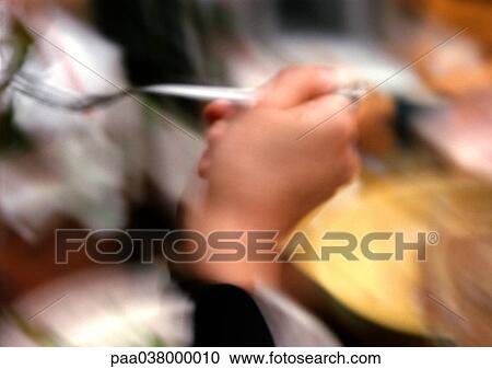 Hand holding fork, close-up, blurred View Large Photo Image Stock Image - Hand holding fork, close-up, blurred. Fotosearch