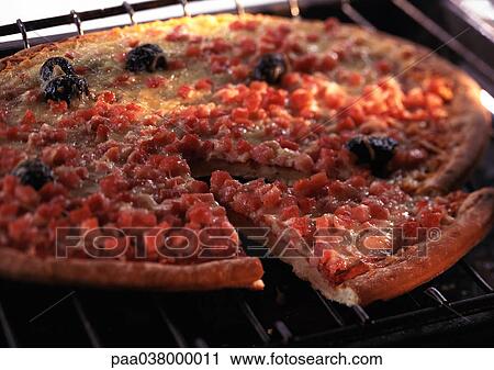 Stock Image - Pizza on oven rack, close-up. Fotosearch