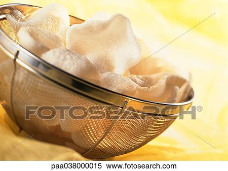 Stock Photography - Shrimp chips in basket, close-up. Fotosearch