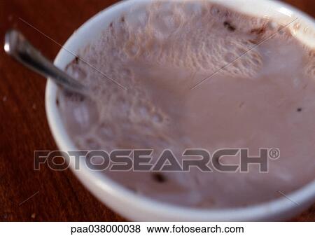 Stock Photo - Spoon in bowl of hot chocolate, close-up. Fotosearch