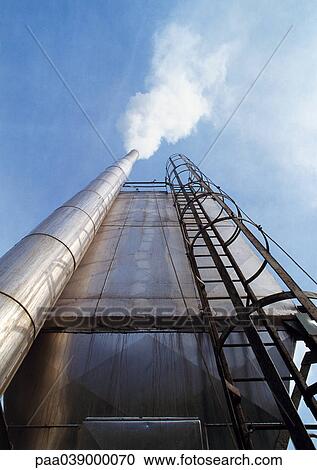 Stock Image - Chimney and ladder, low angle view. Fotosearch