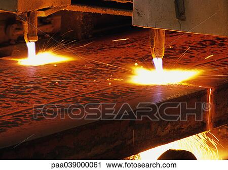 Stock Image - Cutting torches in steel factory, close-up. Fotosearch