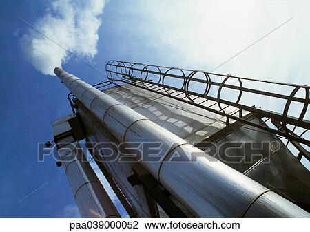 Stock Image - Ladder and plant chimney, low angle view. Fotosearch
