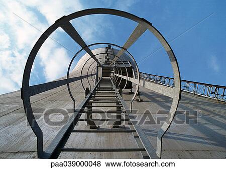 Ladder going up side of concrete tower, low angle view, blue sky with clouds in background View Large Photo Image Stock Photo - Ladder going up side of concrete tower, low angle view, blue sky with clouds in background. Fotosearch