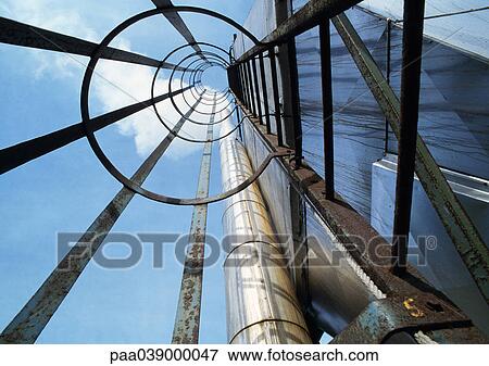 Stock Photo - Ladder on side of building, low angle view. Fotosearch