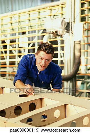 Man in coveralls behind woodwork, looking into camera, head and shoulders View Large Photo Image Stock Photo - Man in coveralls behind woodwork, looking into camera, head and shoulders. Fotosearch