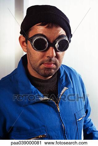 Man in coveralls wearing protective glasses, portrait View Large Photo Image Stock Image - Man in coveralls wearing protective glasses, portrait. Fotosearch