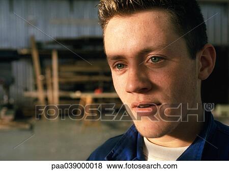 Stock Photo - Man in workshop, close-up, portrait. Fotosearch