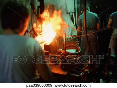 Man working in glass factory, rear view View Large Photo Image Stock Photo - Man working in glass factory, rear view. Fotosearch