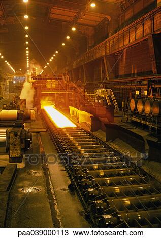 Stock Image - Molten steel in rolling mill, long shot. Fotosearch