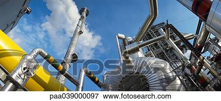 Stock Photo - Power plant, low angle view, blue sky in background. Fotosearch