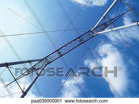 Stock Image - Pylon and electric wires, low angle view. Fotosearch