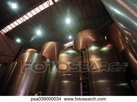 Picture - Wine vats in factory, low angle view. Fotosearch