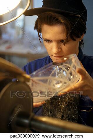 Stock Photo - Woman engraving glass bowl, close-up. Fotosearch