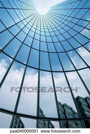 Stock Image - Building reflected in skyscraper's facade, low angle view. Fotosearch