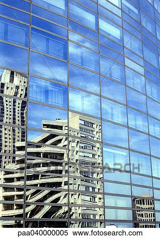 Stock Photography - Buildings reflected in window panes of skyscraper. Fotosearch