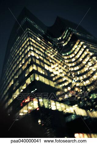 Skyscraper at night, low angle view View Large Photo Image Stock Image - Skyscraper at night, low angle view. Fotosearch