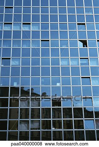 Stock Photo - Skyscraper's facade, buildings reflected in window panes. Fotosearch