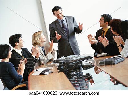 Business people in conference room, applauding businessman standing up View Large Photo Image Stock Photograph - Business people in conference room, applauding businessman standing up. Fotosearch