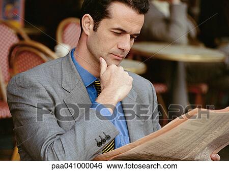 Businessman reading, hand under chin, portrait View Large Photo Image Stock Photograph - Businessman reading, hand under chin, portrait. Fotosearch