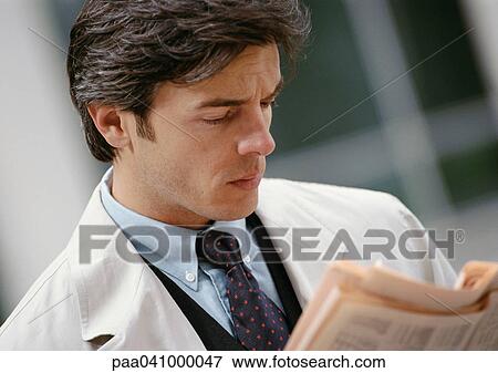 Businessman reading newspaper, portrait View Large Photo Image Stock Photo - Businessman reading newspaper, portrait. Fotosearch