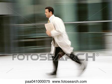 Businessman running in front of building, blurred View Large Photo Image Stock Photography - Businessman running in front of building, blurred. Fotosearch