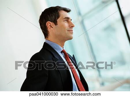 Businessman, side view View Large Photo Image Stock Image - Businessman, side view. Fotosearch