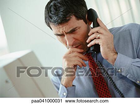 Businessman speaking on telephone View Large Photo Image Stock Image - Businessman speaking on telephone. Fotosearch