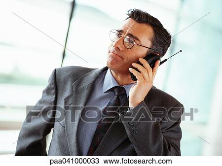 Businessman using phone, portrait View Large Photo Image Stock Image - Businessman using phone, portrait. Fotosearch