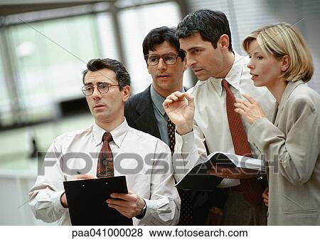 Four business people standing side by side, talking View Large Photo Image Stock Photo - Four business people standing side by side, talking. Fotosearch
