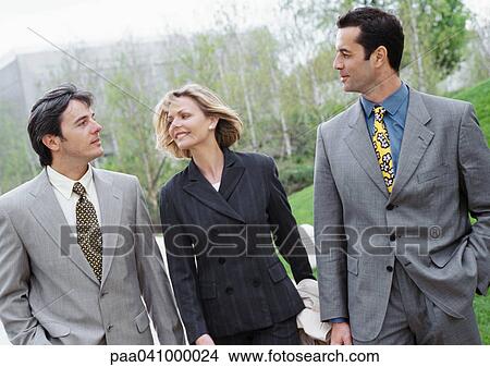 Three business people walking outside View Large Photo Image Picture - Three business people walking outside. Fotosearch