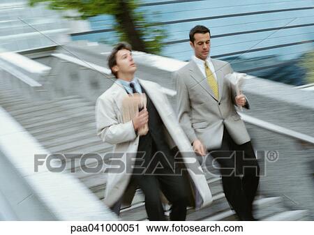 Two businessmen going down stairs side by side, blurred View Large Photo Image Stock Image - Two businessmen going down stairs side by side, blurred. Fotosearch