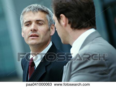 Two businessmen outside, side by side, close-up View Large Photo Image Stock Image - Two businessmen outside, side by side, close-up. Fotosearch